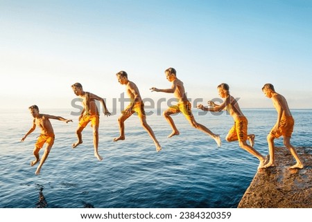 Sequence of jump. Moments of schoolboy jumping from stone pier into sea at sunrise doing tricks in combined image sequence
