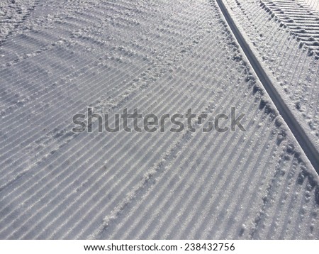 Fresh snow groomer tracks on a ski resort