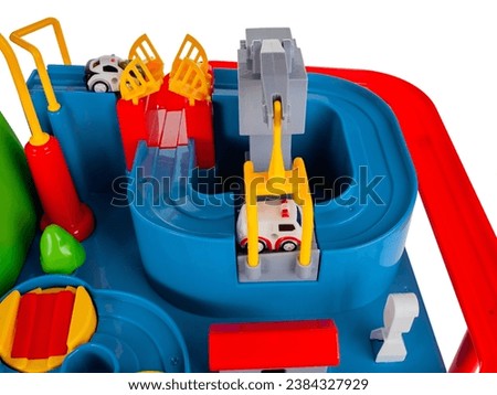 Children's toy slide with obstacles for passing cars along the road toys for kids isolated on a white background close-up