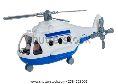 Toy children's plastic helicopter with propeller isolated on white background close-up