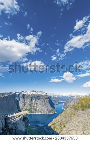 Trolltunga or Troll's Tongue is located close to the town of Odda in Norway, and is a popular attraction and heavily visited  during the summer months in Norway. Royalty-Free Stock Photo #2384337633