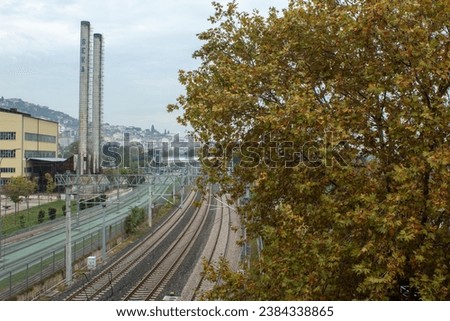 train track, factory, tramway and tree in the same frame, factory chimneys, autumn picture