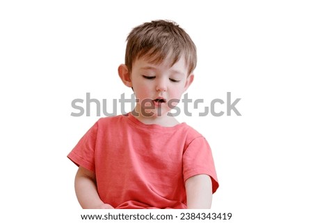 The cute baby is playing with the colorful picture book, flipping through the pages and touching the pictures, isolated on white background. Kid aged about two years (one year ten months)