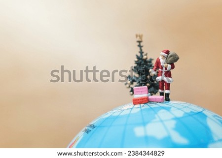 Miniature people : Santa Claus holding gift for kids , Merry christmas concept.
