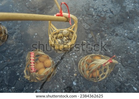 Boiled eggs in natural hot springs. Chicken eggs in basket of tourists boiled in mineral and natural hot water at Chae Son National Park Lampang, Thailand..