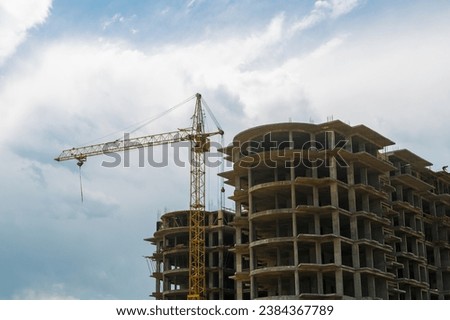 Tower crane on the construction of a multi-storey building. Horizontal photo