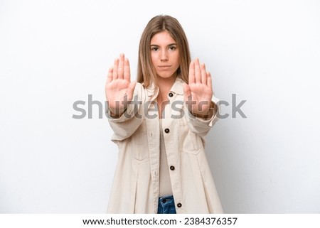Young caucasian woman isolated on white bakcground making stop gesture and disappointed