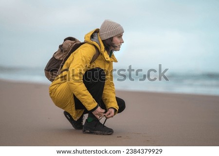 Beautiful woman traveler enjoying autumn hiking at the seaside. Active lifestyle