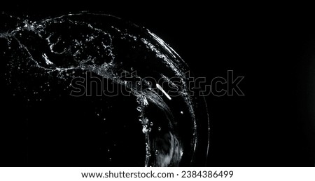 Water spurting out ans Splashing against Black Background Royalty-Free Stock Photo #2384386499