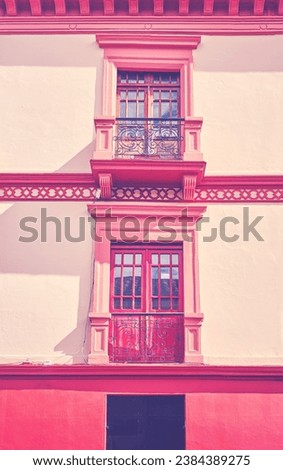 Street view of an old colonial building facade in Quito, color toning applied, Ecuador.