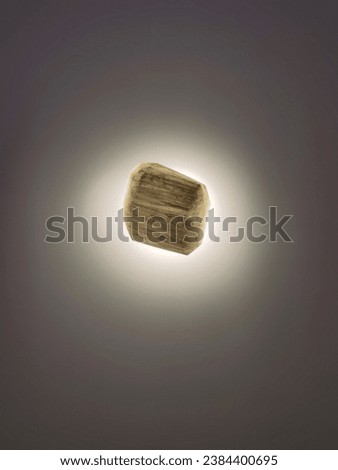 The beautifully cut cylindrical selenite glows in the dark. Royalty-Free Stock Photo #2384400695