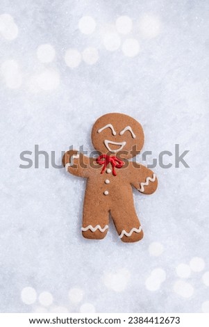 Cute Gingerbread man for Christmas card. Cozy concept of Christmas and winter holidays. Top view. Royalty-Free Stock Photo #2384412673