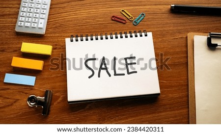 There is notebook with the word SALE. It is as an eye-catching image.