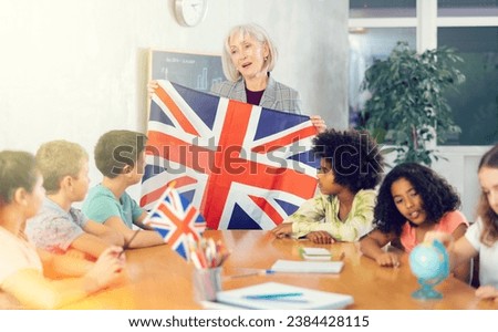 curious students listen attentively to the teacher who tells interesting facts about Great Britain