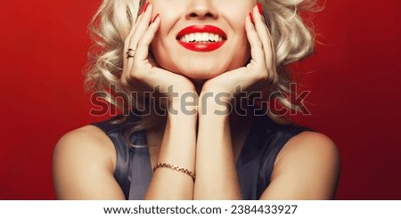 Material girl and femme fatale concept. Marilyn Monroe, Madonna style. Close up portrait of rich young woman smiling wearing expensive luxurious golden ring, bracelet. Perfect shiny smile. Studio shot Royalty-Free Stock Photo #2384433927
