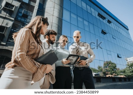 A business team discusses ideas and strategies for expansion and profitability in the city. They analyze the market and focus on customer relations and product innovation. Royalty-Free Stock Photo #2384450899