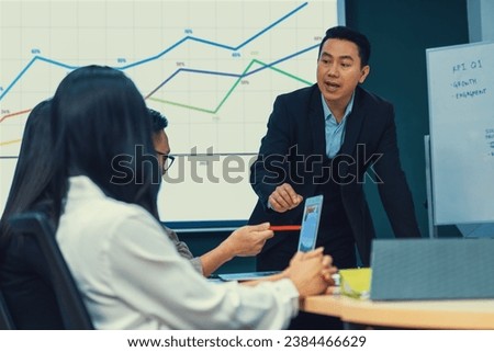 Successful businessman presenting his financial plan and data analyst with confident. group of executive editor focusing on his performance intentionally. Office Conference room meeting. Intellectual.