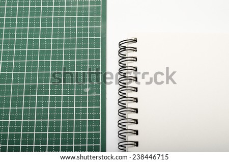 notebook and cutting mat on a white background