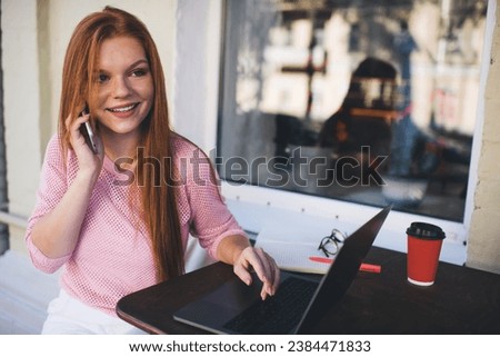 Smiling woman talking on smartphone