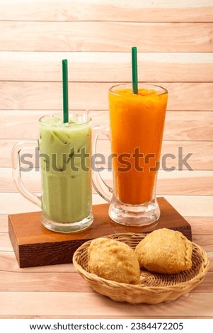 Thai  Latte Milk Green Tea, Milk matcha ice cream tea glass, popular traditional drink, fresh smoothie sweet dessert, vintage wooden table cafe. Cold cappuccino coffee cup, isolated white background
