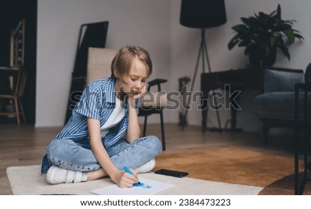 Boy creating picture on floor