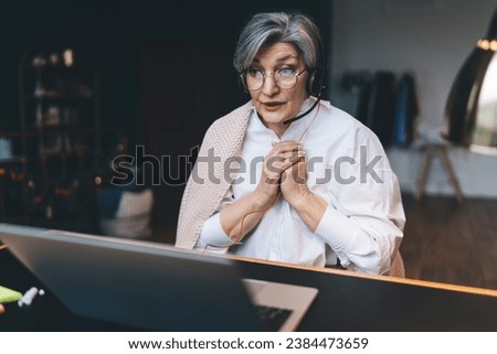 Cheerful mature woman using laptop