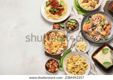 Assortment of Italian pasta dishes on light bachground. Traditional food concept. Top view, copy space.