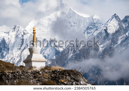 Tibetan Buddhist stupa on the way to Kyangjin Kharka village in Langtang National park in Nepal. The Langtang Valley is mainly inhabited by the Tamang people they mainly follow Tibetan Buddhism. Royalty-Free Stock Photo #2384505765