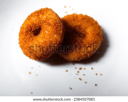 closeup of two sweet and soft palm sugar donuts isolated on white background.  top view