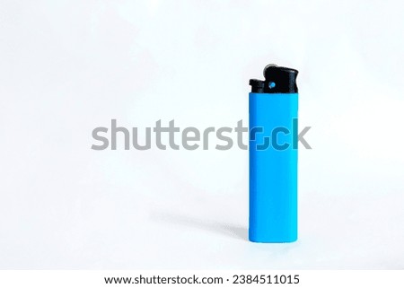 Blue plastic lighter on white background Royalty-Free Stock Photo #2384511015