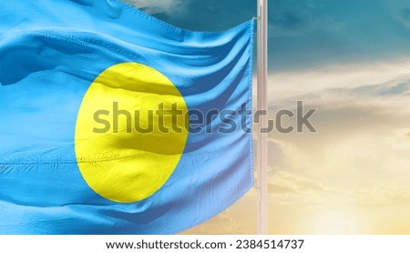 Palau national flag waving in beautiful sky. The flag waving with dynamic angle. Royalty-Free Stock Photo #2384514737