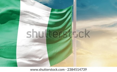 Nigeria national flag waving in beautiful sky. The flag waving with dynamic angle.