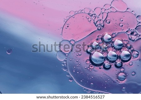 Colorful artistic of oil drop floating on the water Royalty-Free Stock Photo #2384516527