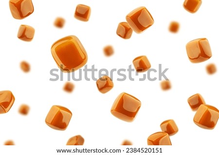 Falling Caramel candy, isolated on white background, selective focus Royalty-Free Stock Photo #2384520151