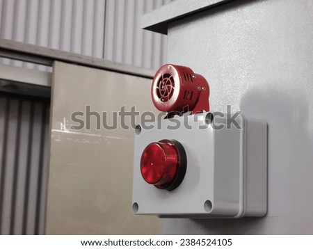 Alarm siren with strobe light mount on electrical cabinet.