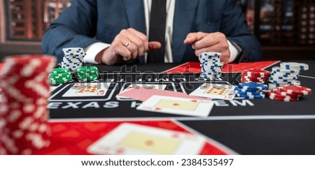 Male player hold poker card play a game for chance to win at casino.  Gambling concept. Luck and fortune  Royalty-Free Stock Photo #2384535497