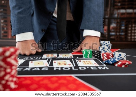 lucky guy in suit hold card and chips play poker at casino. Gambling concept Royalty-Free Stock Photo #2384535567