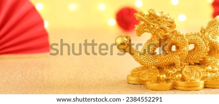 Golden figurine of Chinese dragon on yellow background with space for text