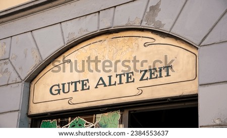 the picture shows a signpost and a sign that points in the direction of good old times in german.