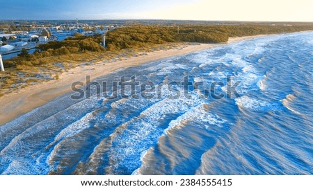 Western beach in Kolobrzeg. Photo from a drone on a clear September day at the beach and rough sea with waves.
