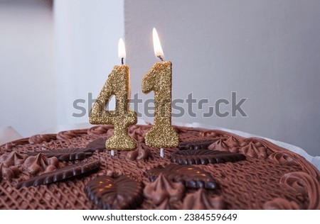 Birthday chocolate cake with candles number 41.