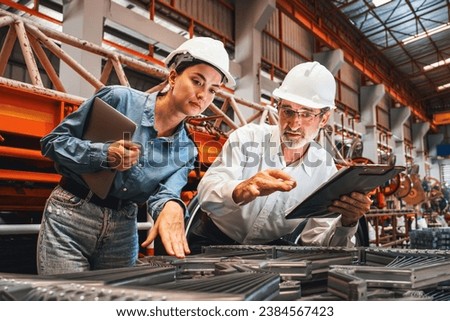 Metalwork manufacturing factory manager oversees highest quality of metal or steel frame for heavy construction. Steel manufacture inspection ensuring precision quality product. Exemplifying Royalty-Free Stock Photo #2384567423