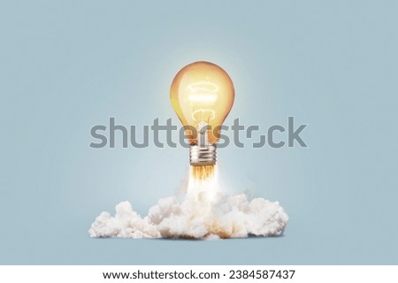 Creative light bulb rocket with blast and smoke takes off on a blue background, concept. Successful launch and development, creative idea. Think differently. Creative generator. Smart and thinking Royalty-Free Stock Photo #2384587437