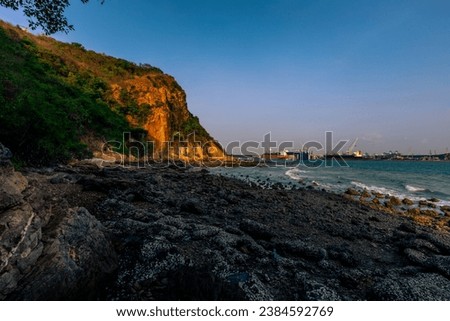 The background of the sea by the evening sea, with natural beauty (sea water, rocks, sky) and fishermen are fishing by the river bank, is a pleasure during travel.