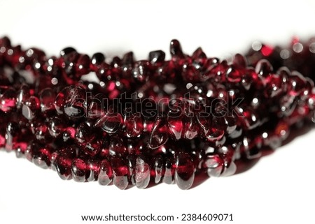 Beads in the form of a crumb of a natural garnet. Royalty-Free Stock Photo #2384609071