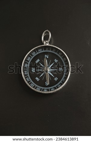 Compass on black. Magnetic compass on a dark background.