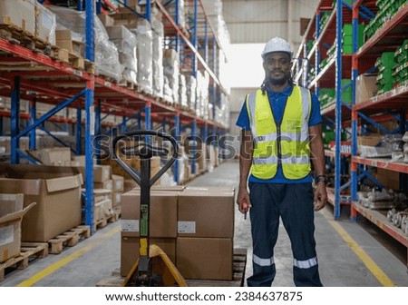 Portrait of male supervisor standing one person at storage shelf in warehouse looking at camera. Confident multiracial logistic manager employee wear safety uniform working with stock in storehouse.