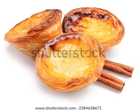 Pastel de nata tarts and cinnamon sticks isolated on white background. 