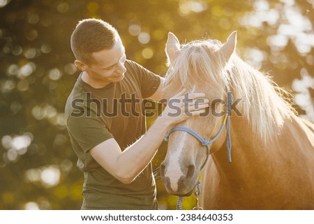 Man is embracing of therapy horse. Themes hippotherapy, care and friendship between people and animals.
 Royalty-Free Stock Photo #2384640353