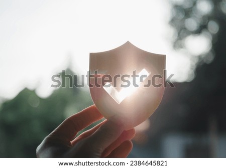 Silhouette of Businessman holding shield protect icon, Security protection and health insurance. The concept of family home, foster care, homeless support, protection, health care day. Royalty-Free Stock Photo #2384645821